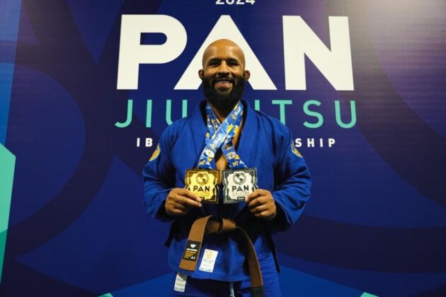 Demetrious Johnson holding his medals in Jiu-JiuJitsu